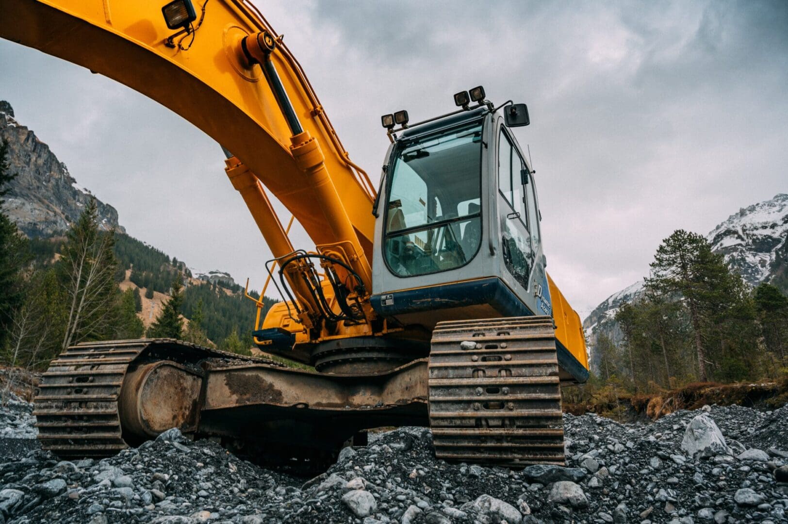 A yellow and black excavator is on the ground